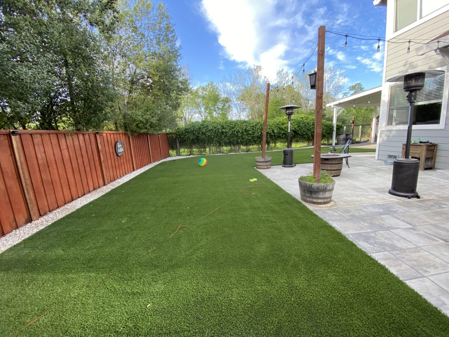 Artificial grass with concrete backyard area, landscaping by Guys Yard Design in Sonoma, CA