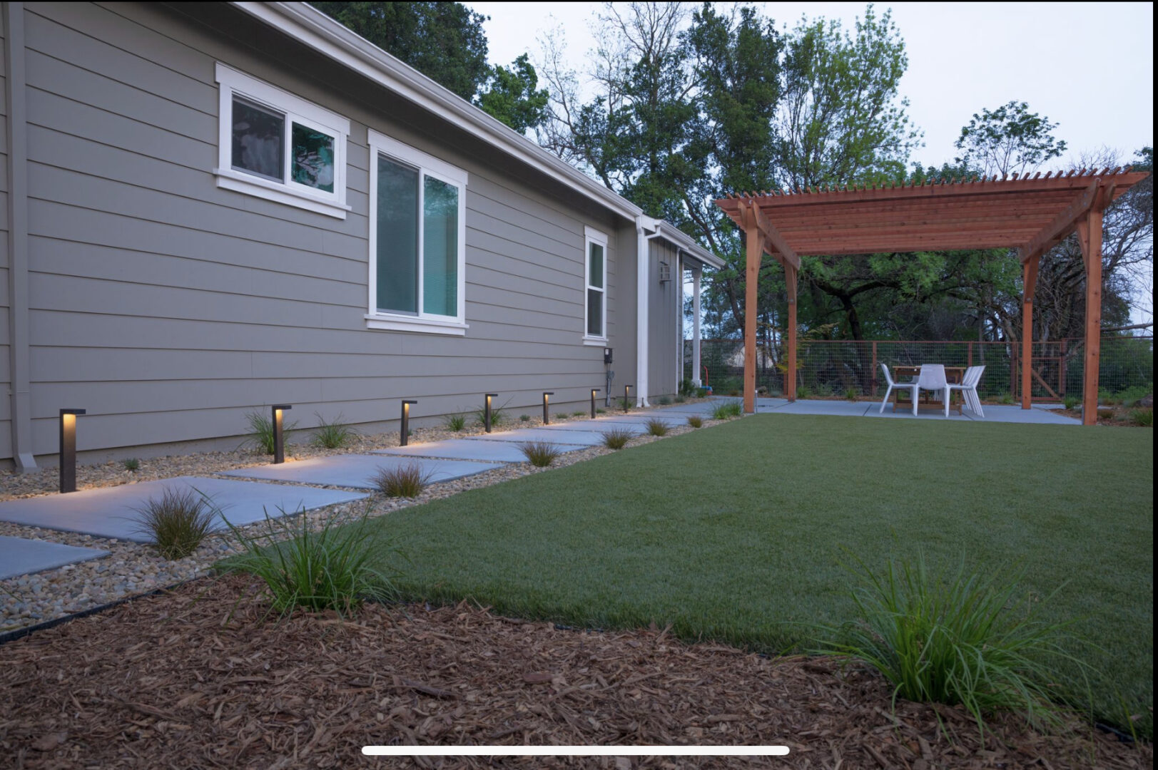 Artificial grass, path light, tiles, outdoor table set, landscaping by Guys Yard Design in Sonoma, CA