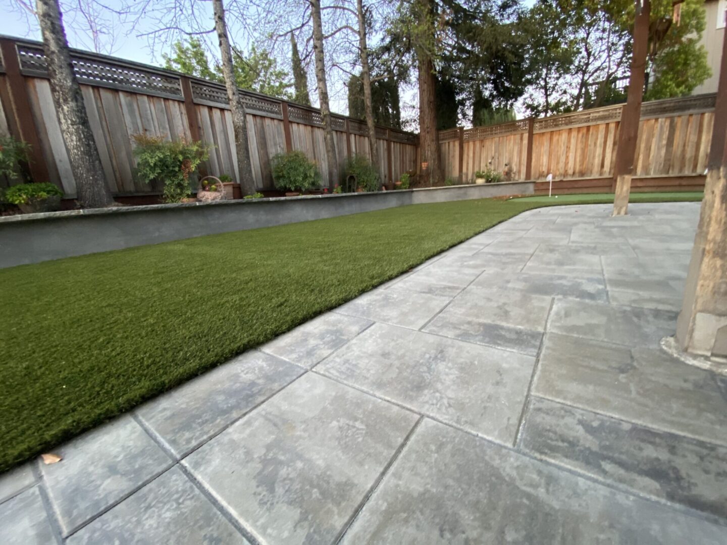Artificial lawn with concrete, trees, landscaping service by Guys Yard Design in Sonoma, CA