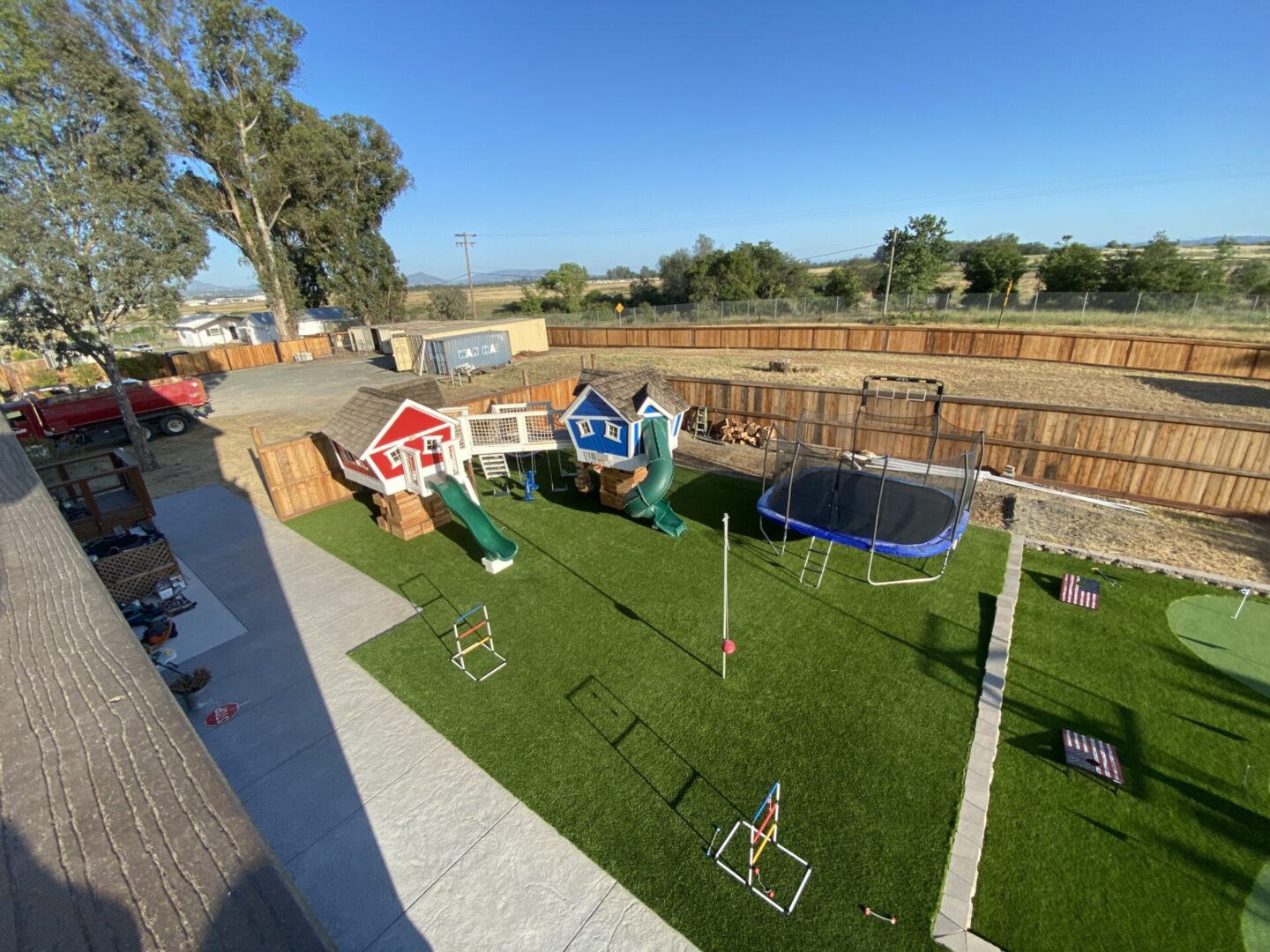 Artificial grass, kids’ playground set, landscaping by Guys Yard Design in Sonoma, CA